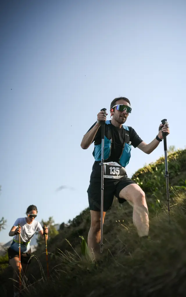 Runner in sportswear climbing a mountain trail