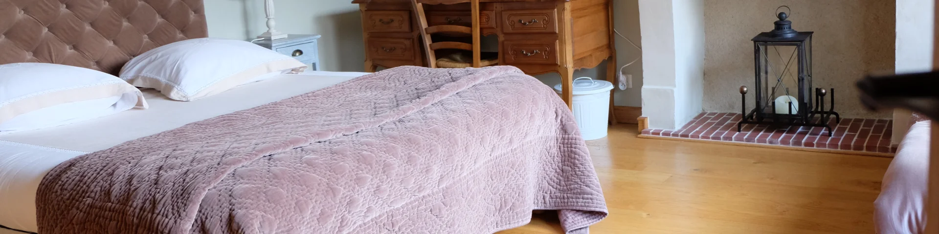 Entrée d'une chambre avec lit, cheminée, bureau