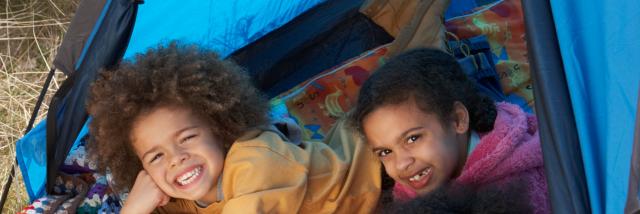Children Having Fun Inside Tent On Camping Holiday