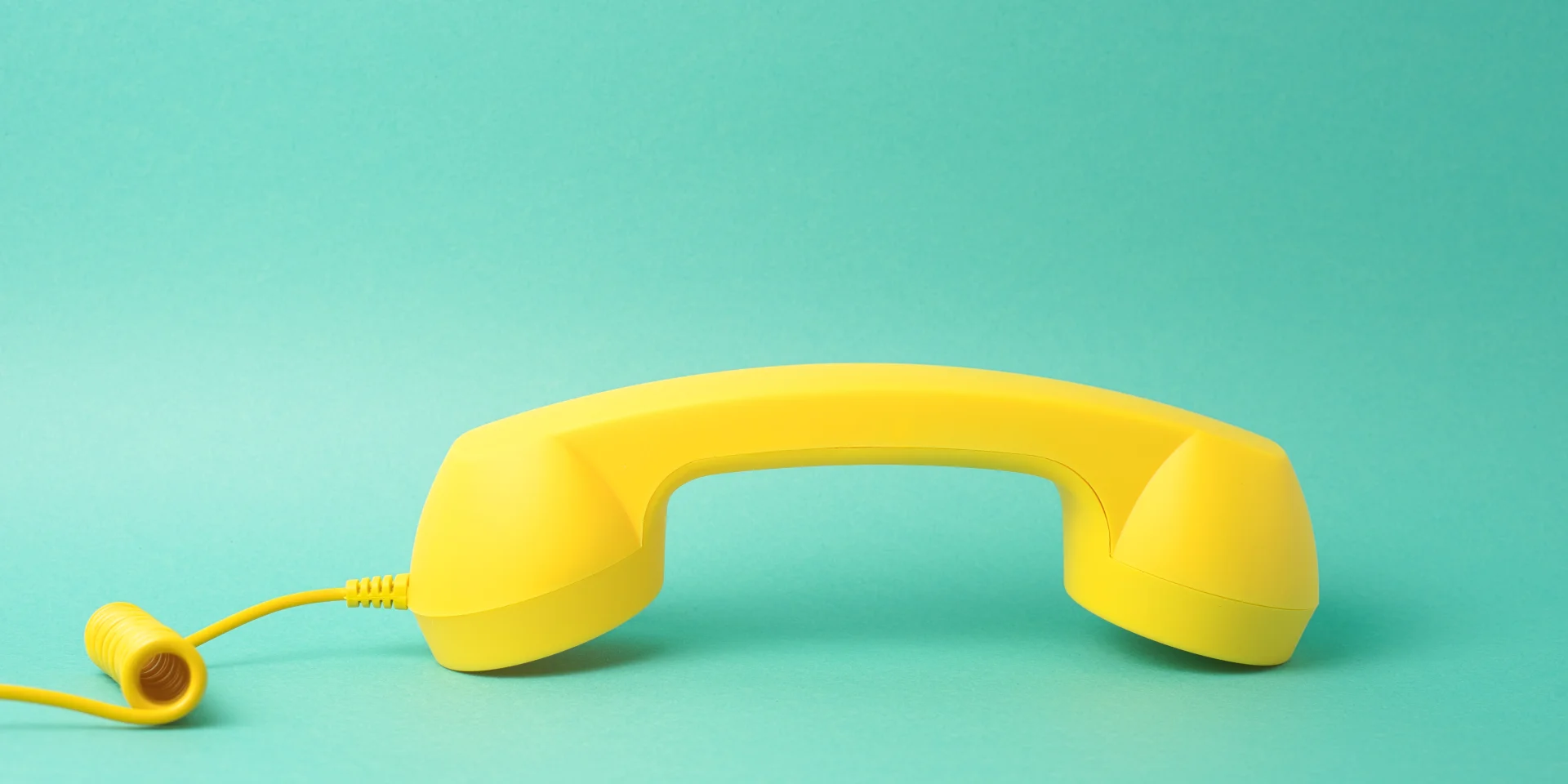 Yellow Telephone Receiver Turquoise Background