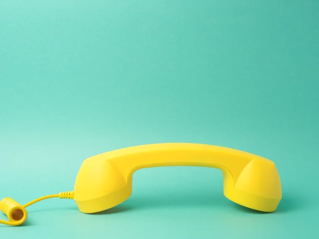 Yellow Telephone Receiver Turquoise Background