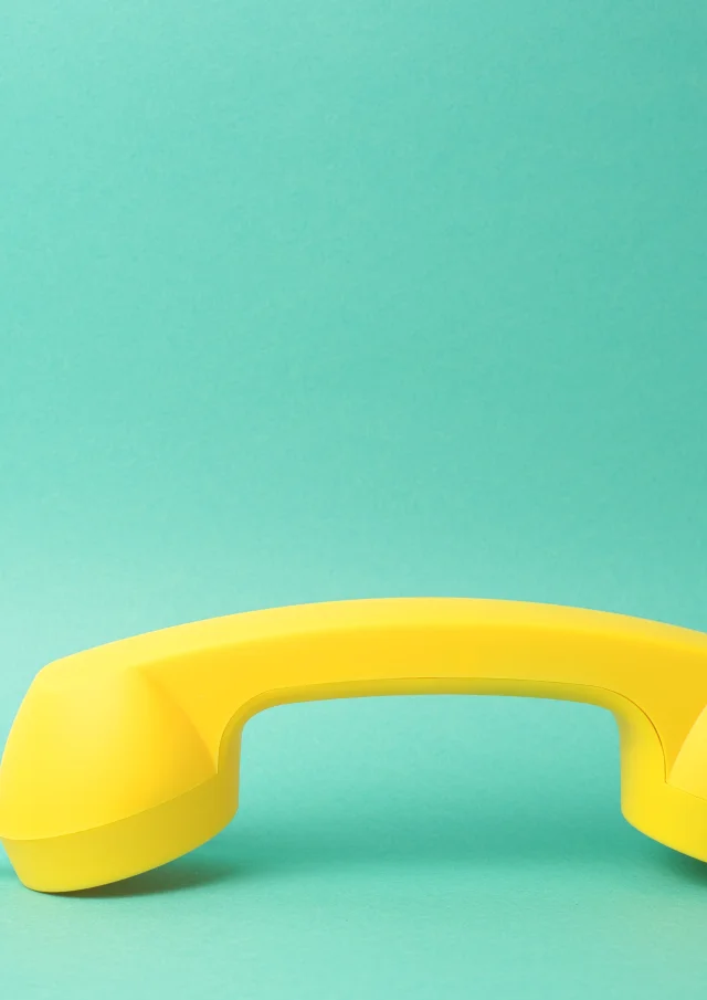 Yellow Telephone Receiver Turquoise Background
